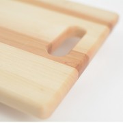 Wood cutting board with handle rounded edges.